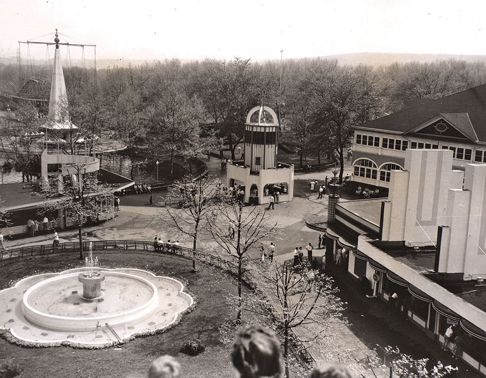 Photographed in the late 1950s atop a Ferris wheel at the end of the new mall are, clockwise, the mall fountain, Novelty stand, Rockets above the lagoon, Tower stand with Space Age roof treatment, 1899 cafeteria and Sportland building (which had been moved and turned 90 degrees to create the mall fountain).