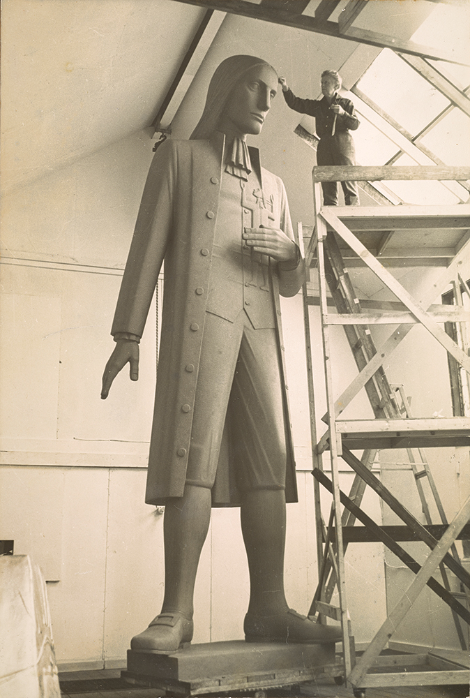 On scaffolding, de Coux works on the 17-foot, 6-inch model in her studio, 1964. The base would add another 6 inches, bringing the full height of the statue to 18 feet. Janet de Coux papers, Archives of American Art, Smithsonian Institution