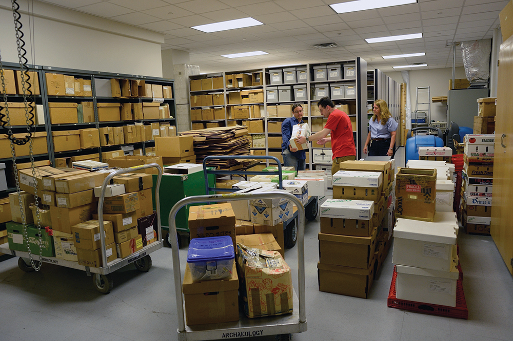 State Museum archaeology curators David Burke, left, and Janet Johnson, right, and intern Sam Azzaro, middle, unload roughly 50,000 artifacts donated by brothers Bob and Jim Oshnock. The State Museum of Pennsylvania