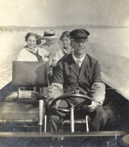 Hunter takes his family for a ride on a powerboat during a vacation in the Thousand Islands, near Alexandria Bay, New York, c. 1906.