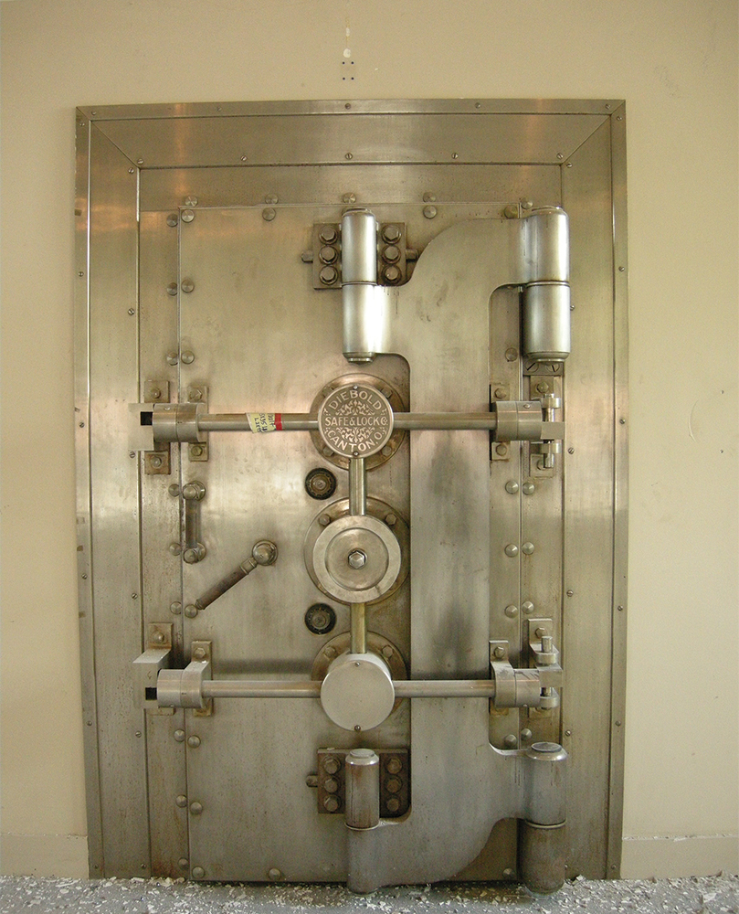 The bank's vault door, with a plaque identifying the architect Tilghman Moyer, was retained in the renovation and now is the entry to a private dining room. State Historic Preservation Office