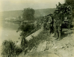 Members of the 103rd Engineer Regiment recover a sunken boat that had been part of a pontoon bridge on the Marne River at Jaulgonne, France, July 29, 1918.