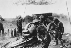 Soldiers in Battery A, 108th Field Artillery, under attack by enemy gas shells, fire toward Chatel-Chéhéry, October 3, 1918. National Archives