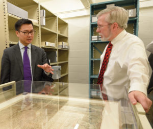 Lord Wei, left, discusses Penn’s 1681 Charter of Pennsylvania with David Carmicheal, director the State Archives, right.
