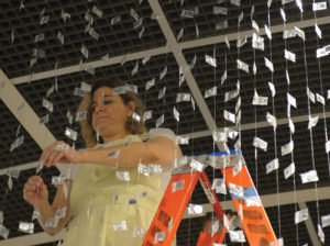 Maria Maneos of North Wales installs her work 5535-2017(5535 Opioid/Heroin Deaths in Pennsylvania in 2017), which received first prize in sculpture.