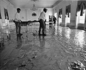 The State Dining Room and the ground floor and basement of the residence were flooded. Staff moved furniture and pinned up floor-length draperies to minimize damage. Pennsylvania State Archives / MG-309