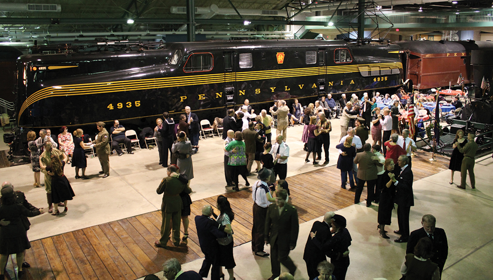 Dancers of all ages jump and jive to live music at the 1940s swing dance held amid the historic trains in Rolling Stock Hall at the Railroad Museum of Pennsylvania during its annual Trains & Troops tribute weekend.
