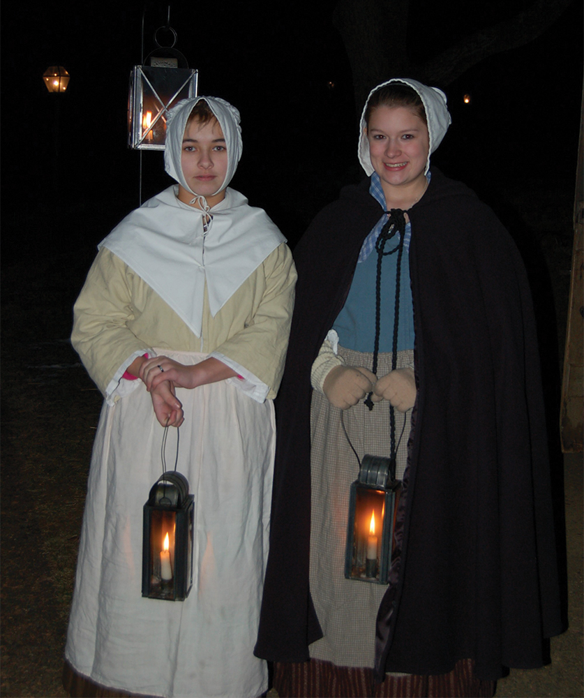Abby Van Roy and Alexa Aron greet visitors during a past Lantern Tours event.