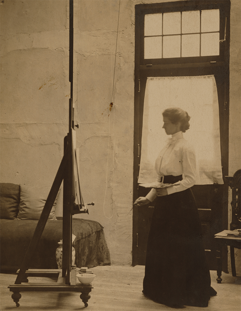 Oakley at easel in her studio, circa 1903.