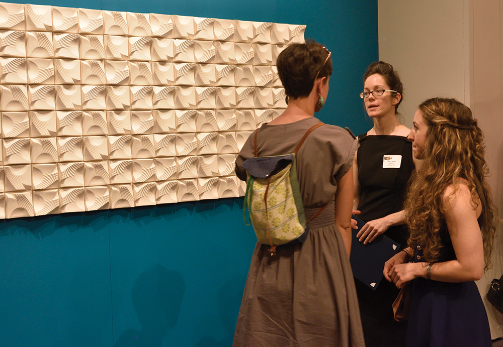 Amy LeFever of Middletown discusses her untitled ceramic piece, which won first prize in craft, at the opening of Art of the State.