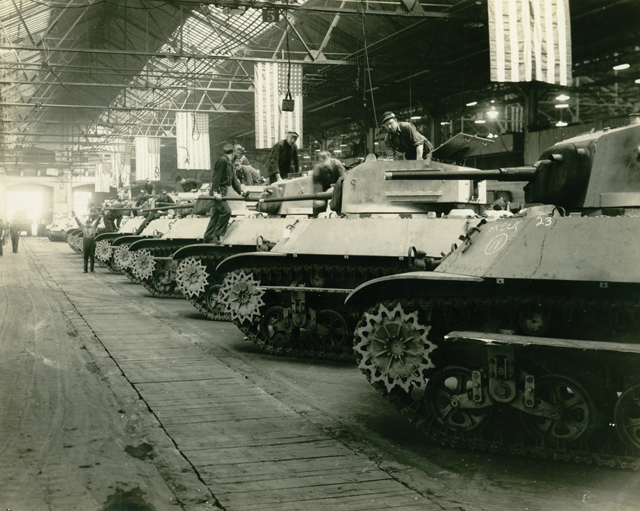 Tanks on the final paint line receiving application of sand guards.