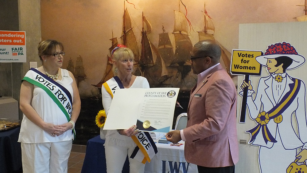 Christal Lepak and Lori Morse-Dolan of the Erie County Chapter of the League of Women Voters accept a proclamation honoring women’s suffrage from Gary Lee, Erie County director of administration, in the lobby of the Erie Maritime Museum, June 24, 2019. Erie Maritime Museum, PHMC / Linda Bolla