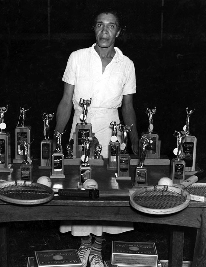 Ora Washington poses behind her awards for photographer by John W. Mosley at the Pennsylvania Open tennis tournament in July 1939. John W. Mosley Photograph Collection, Charles L. Blockson Afro-American Collection, Temple University Libraries, Philadelphia