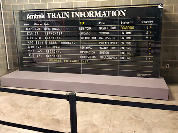 The 30th Street Station Solari board, the last one to have been in service for Amtrak, sits securely on its new base along Platform 5 West, near the Railroad Museum's yard entrance. Railroad Museum of Pennsylvania, PHMC