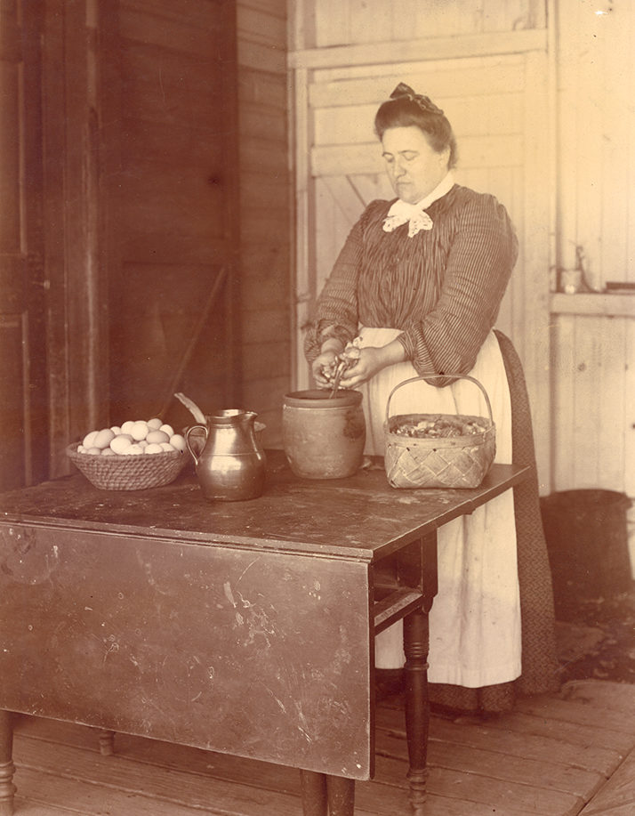 In this circa 1915 photograph by H. Winslow Fegley, a Pennsylvania Dutch woman of the Perkiomen Valley peels onion skins for dyeing eggs. Schwenkfelder Library & Heritage Center, Pennsburg, PA
