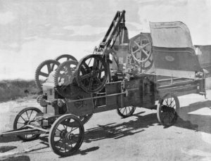 A bale press with the feeder at upper right, atop the baling chamber. Such bale presses were used from about the 1870s through the 1940s. Pulled to the location of use, they remained stationary while belted by pulley to an engine or horse-powered mechanism. Courtesy Gwendolyn Ruth Dickinson