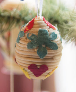 A contemporary Easter egg decorated with coils of binsegraas by artist Elaine Vardjan, a senior member of the Pennsylvania Guild of Craftsmen, Berks Chapter. Long strands of bullrush pith are carefully extracted by hand and adhered to the egg with paste. Patches of fabric are also applied to give color and variety. Pennsylvania German Cultural Heritage Center, Kutztown University