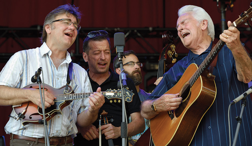 The Del McCoury Band hits a high note—from left to right, Ronnie McCoury on mandolin, Jason Carter on fiddle, Alan Bartram on bass, and Del on guitar. Photo, PHMC