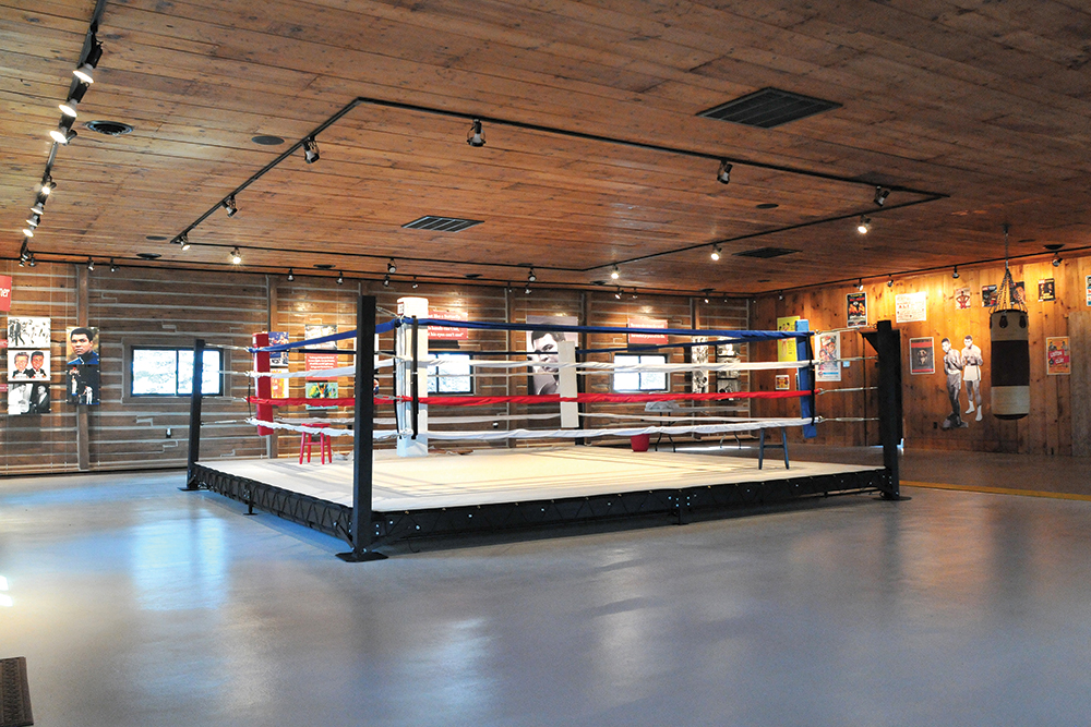 The extensive restoration inside the log gym at Fighter’s Heaven was completed in 2018. It contains a boxing ring and many photographs and videos chronicling Muhammad Ali’s storied career. Photo, ©Jeff Julian
