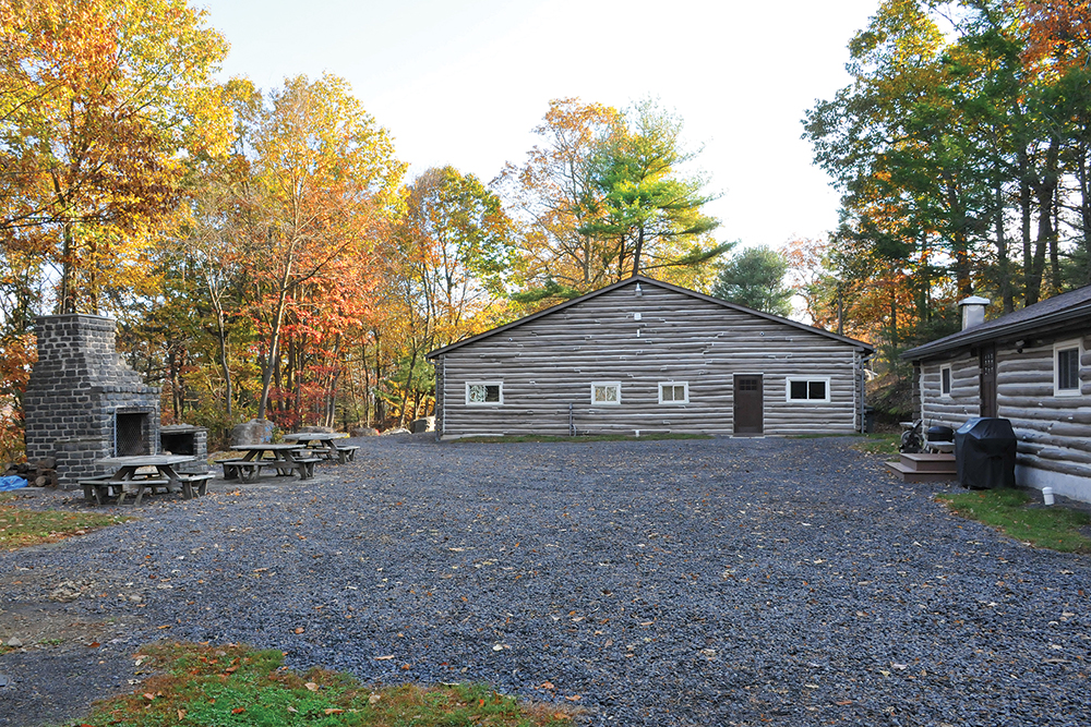 The log gym, center, and kitchen, right, at Ali’s training camp were set in a courtyard with a large outdoor fireplace that served as a focal point for camp members who would gather there to share their special camaraderie. Photo, ©Jeff Julian