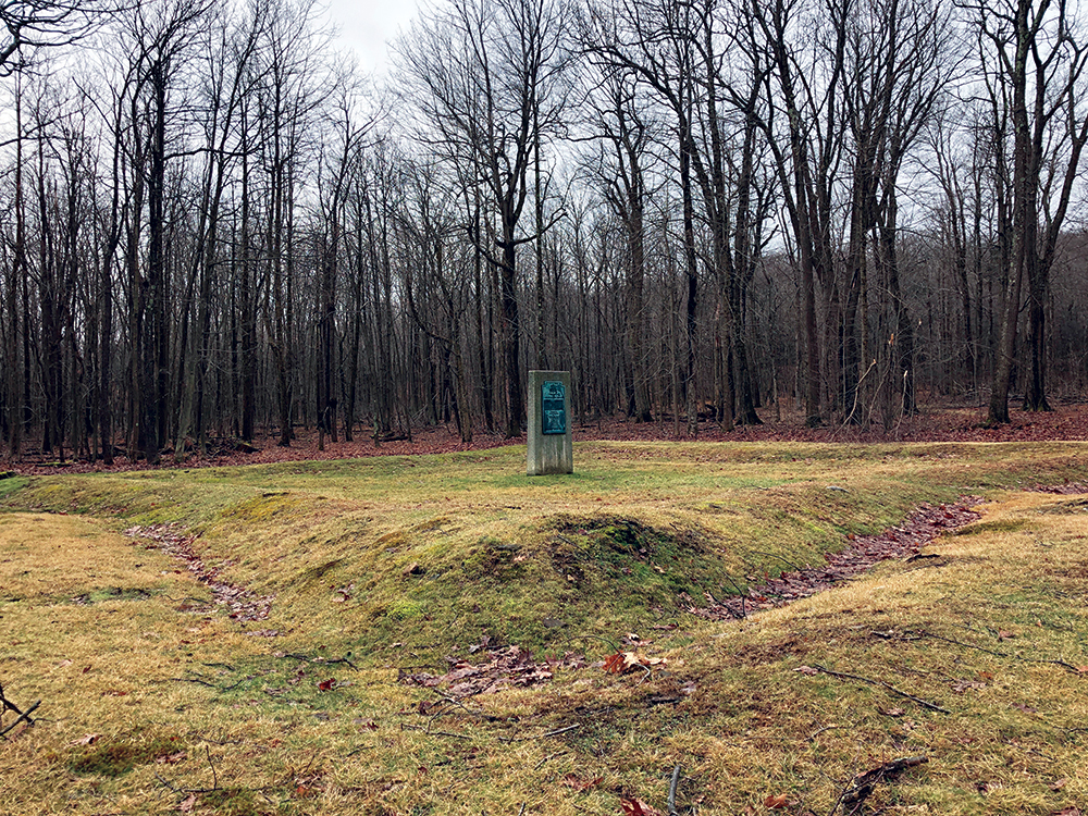 The earthen breastwork outline of Fort Dewart with the 1930 monument in the center. Pennsylvania State Historic Preservation Office