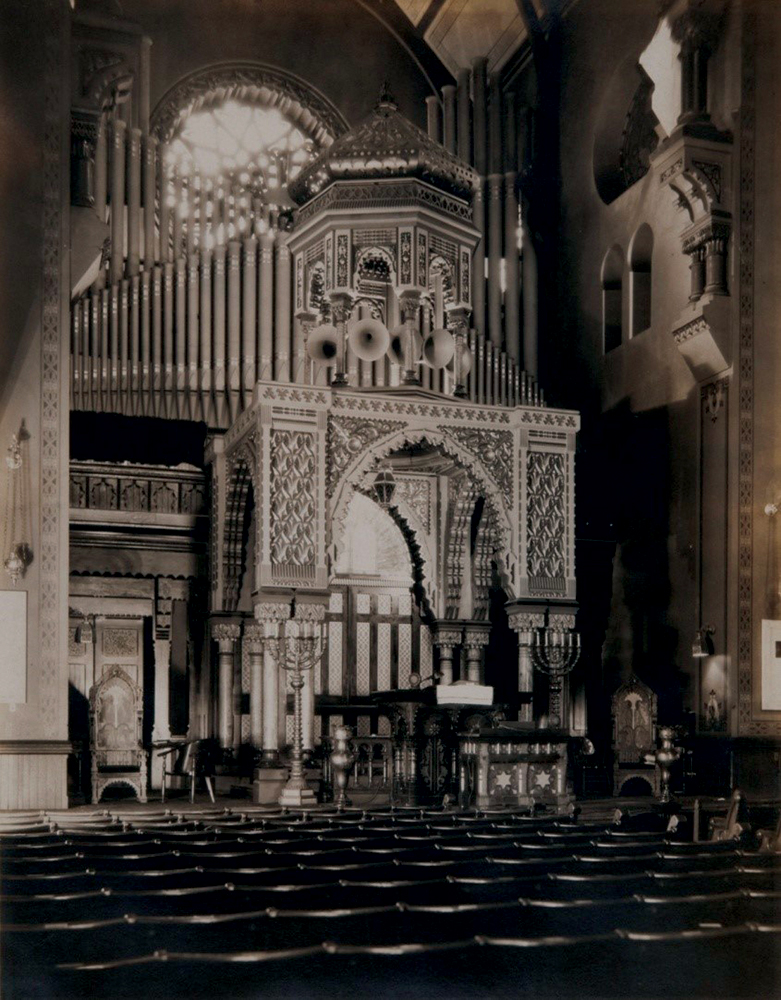 The dramatic, stagelike bimah of Rodeph Shalom with its suite of Furness-designed furniture echoed the temple’s architecture. Oversized, ornamental organ pipes trumpeted the congregation’s tradition-breaking reformist use of instrumental music. Congregation Rodeph Shalom, Philadelphia