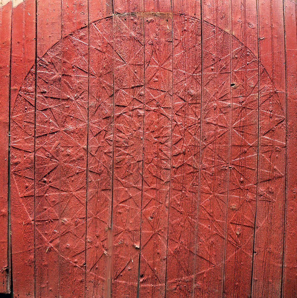 A relief of a barn star, called a “ghost,” forms after decades of direct exposure to the sun and the elements. Geometric areas with multiple layers of paint are protected, while the background gradually recedes. This highly complex ghost is all that remains of an elaborate star from the 1920s, attributed to Milton Hill. Photo, Patrick J. Donmoyer