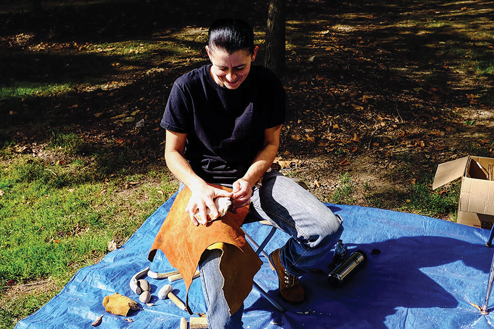 PennDOT archaeologist Susanne Haney demonstrates flintknapping for students at Indiana University of Pennsylvania. Photo courtesy of Ben Ford, Indiana University of Pennsylvania