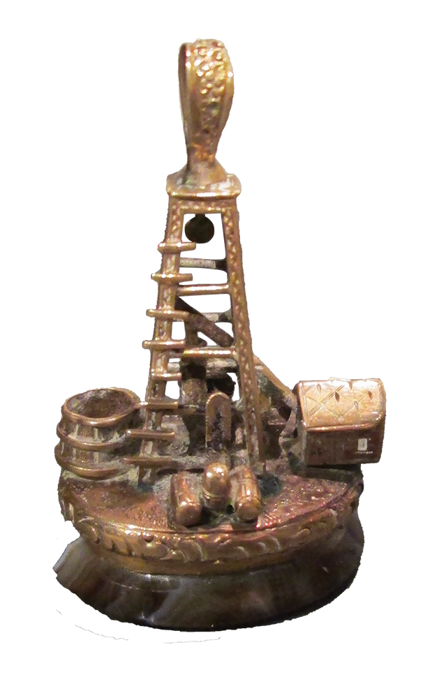 This gold and marble watch fob measures approximately 1.3 inches tall by 0.8 inches wide and was made for oil well operator Harry W. Potter in 1866. Drake Well Museum & Park, PHMC (DW79.11.298)