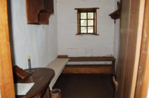 Sisters slept in separate cells, “four paces by two” in size, on narrow wooden benches, their heads propped on small wooden blocks. Ephrata Cloister, PHMC