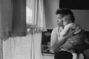 Daisy Myers holds her infant daughter Lynda during the turmoil that followed their move to Levittown in August 1957. Look Magazine Photograph Collection, Library of Congress Prints and Photographs Division