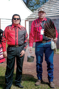 Curtis Zunigha, Delaware Tribe of Indians, and Barton Cartwright, Delaware Nation, burning cedar during the communal gathering. Ellen Henderson Photography