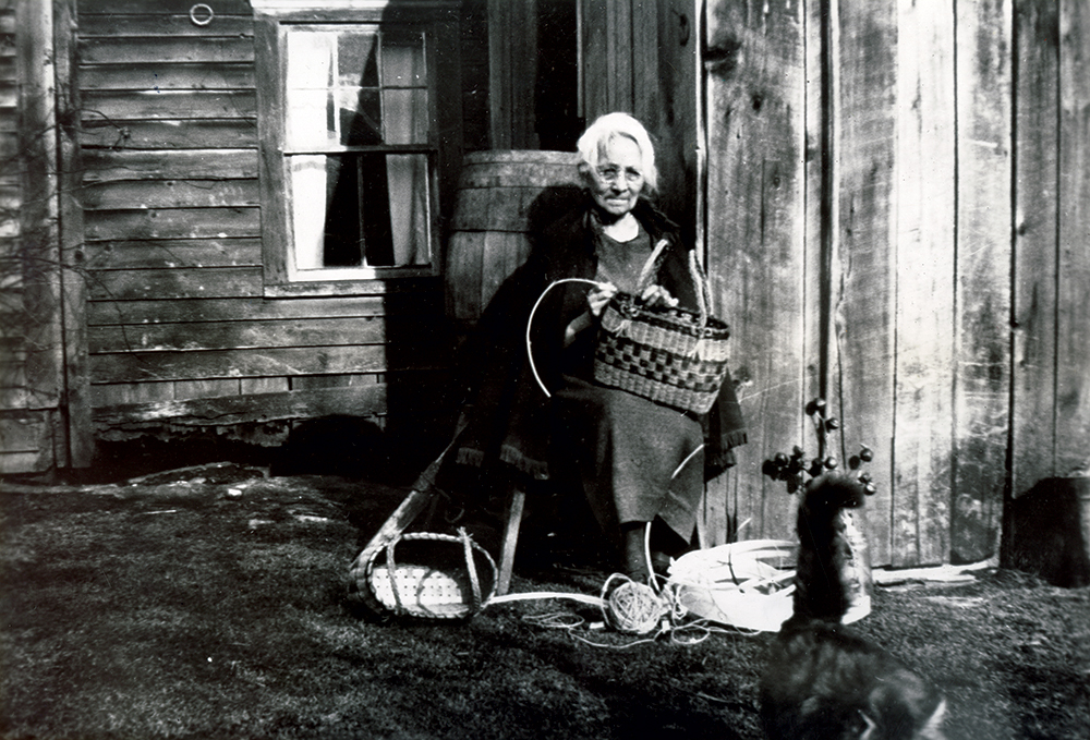 Phoebe Gordon making a splint basket at her Cornplanter home, circa 1940. Pennsylvania State Archives, MG-13