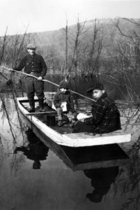 Ezra Jacobs navigates a boat on the Allegheny River near the Cornplanter Grant with his two children, Douglas and Harry, circa 1940. Pennsylvania State Archives, MG-13
