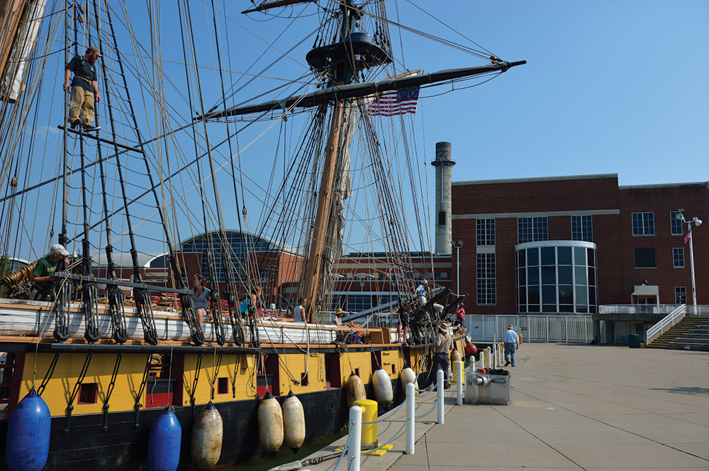 U.S. Brig Niagara docked at Erie Maritime Museum. The curved section of windows on the museum are an observation deck that allows museum visitors to view the ship in all types of weather. Photo, Pennsylvania Historical & Museum Commission