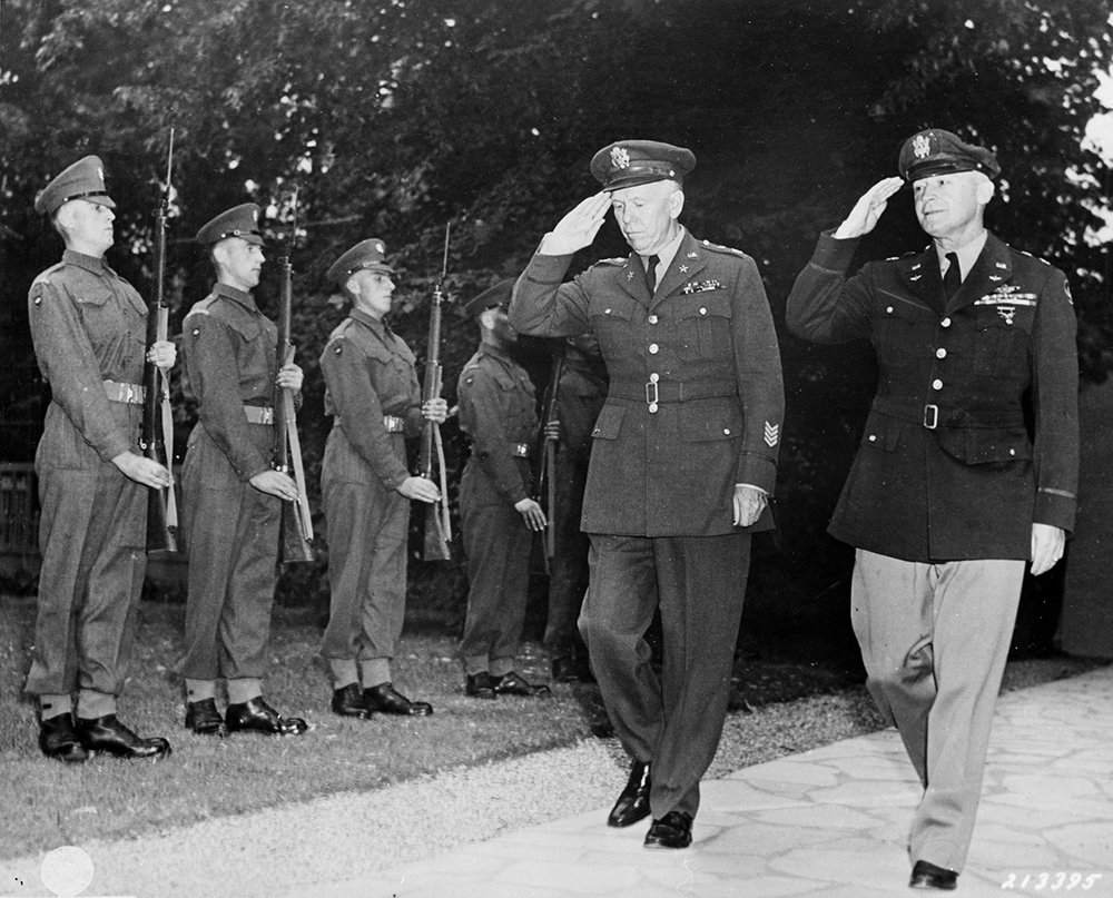 Marshall and fellow Pennsylvania native Gen. Henry H. Arnold return a salute to a line of Scots Guards of the British Brigade of Foot Guards as they arrive at a dinner at Winston Churchill’s residence, July 23, 1945. National Archives and Records Administration