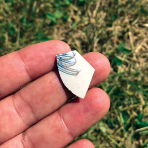 A sherd of 18th-century British “scratch blue” stoneware recovered at an excavation unit. Photo, Joe Baker