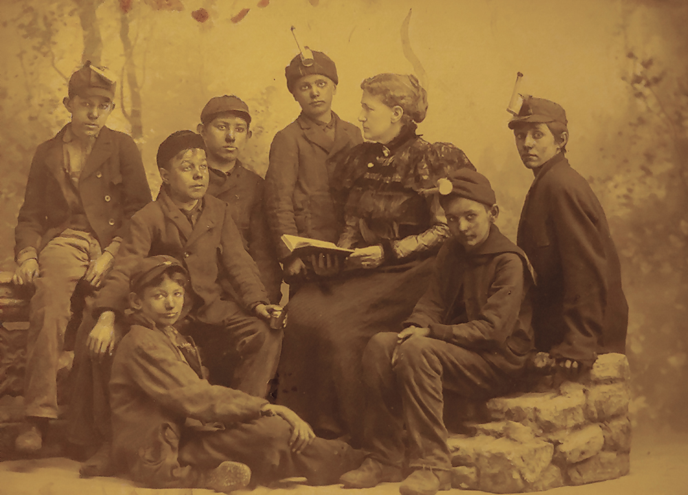 Ellen Webster Palmer (1839–1918), founder of the Boys Industrial Association, reads to a group of breaker boys. Collection of Andrea Lowery