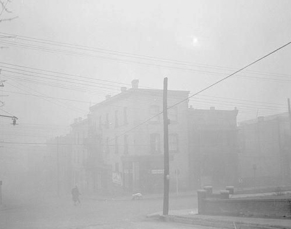 The thick smog envelops a street corner in Donora. Donora Historical Society