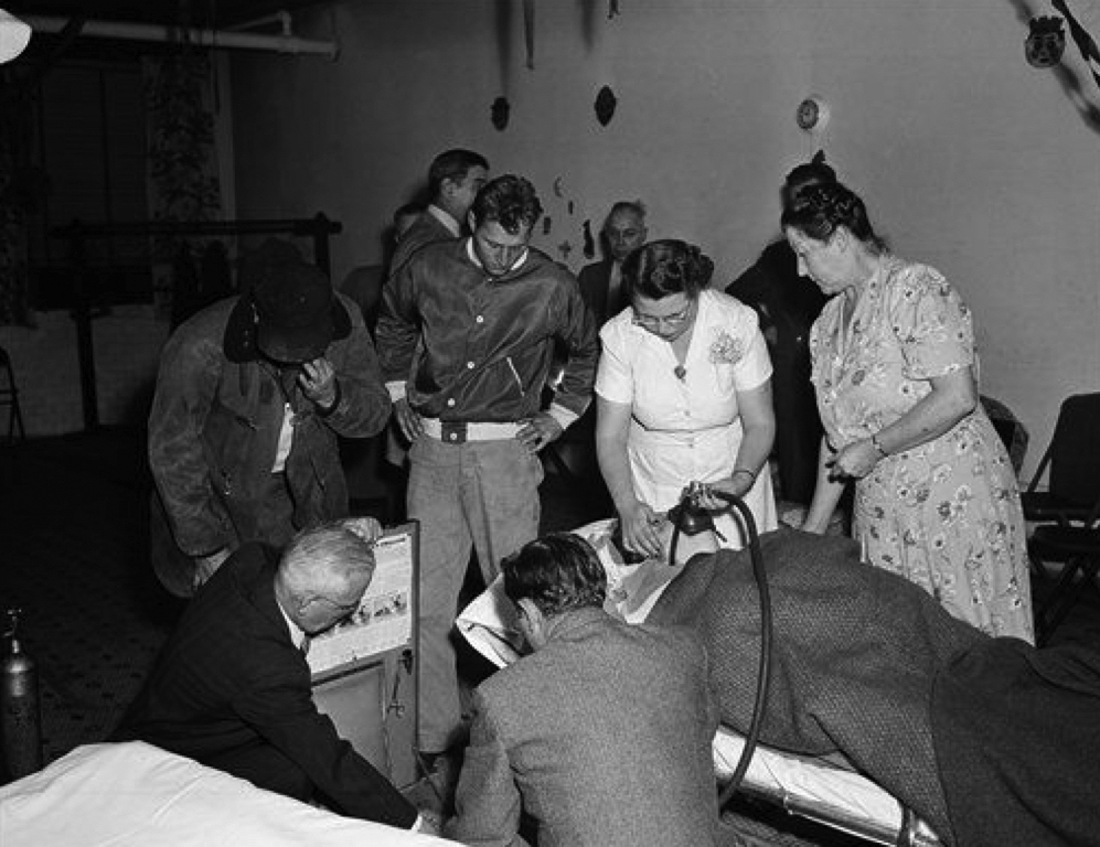 A woman receives oxygen at a makeshift triage center during the smog disaster, October 30, 1948. Donora Historical Society