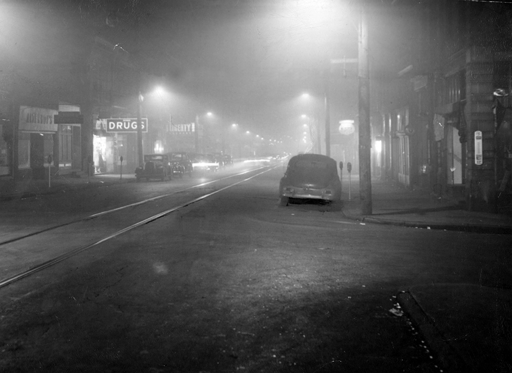 The smog, trapped by a temperature inversion, veils a street in downtown Donora. Pittsburgh Post-Gazette