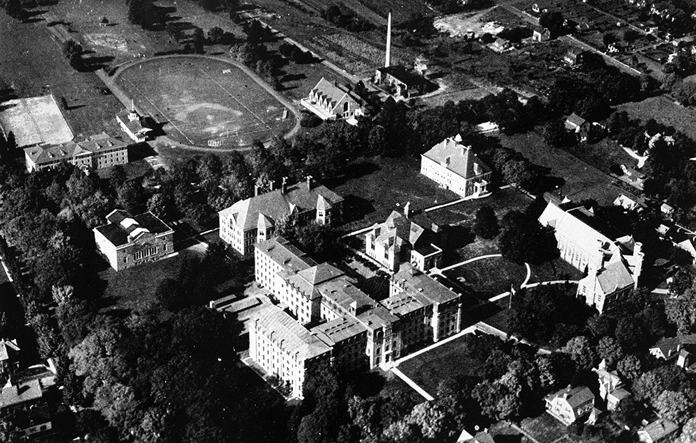 By World War I, Main Hall was sprawling out with its north and south wings, lengthy rear central wing, and south wing annex, here partially hidden by trees. Special Collections, West Chester University