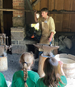 A volunteer of the Hay Creek Valley Historical Association demonstrates in the blacksmith shop at Joanna Furnace. Hay Creek Valley Historical Association