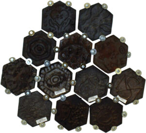 These cast-iron hexagons were created by visitors at a Fire at the Furnaces event at Scranton Iron Furnaces. Each has its own design, but together they symbolize the strength of people connecting in ever-expanding networks. Photo, Pennsylvania Anthracite Heritage Museum
