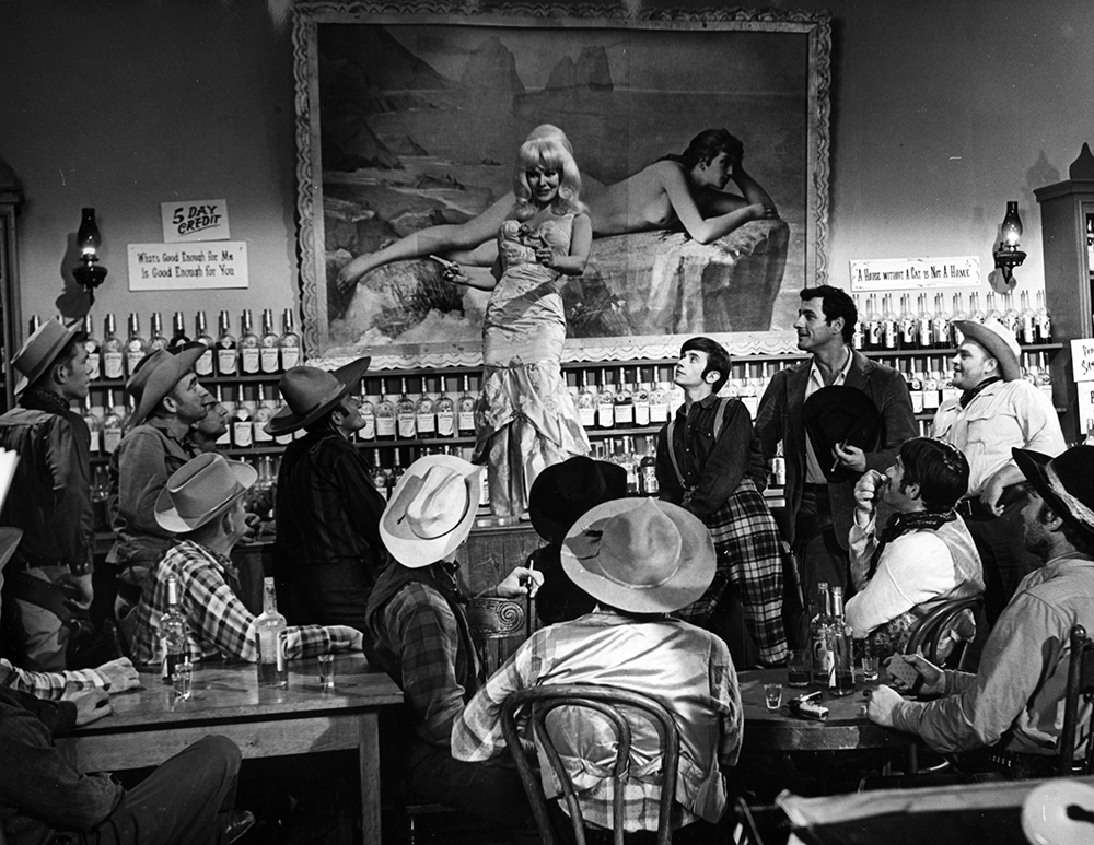 La Belle (Greta Thyssen) wows a tough crowd in Hope Canyon. The majority of the men wearing cowboy hats were local extras. Karl Bissinger Papers, University of Delaware Library