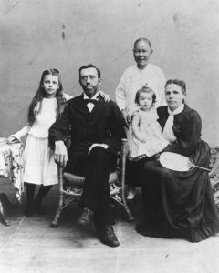 The Sydenstricker family in China, circa 1900. Pearl has her arm around her father Absalom, and her nanny, Wang Amah, stands behind mother Caroline who is holding baby Grace. Pearl S. Buck International Archives