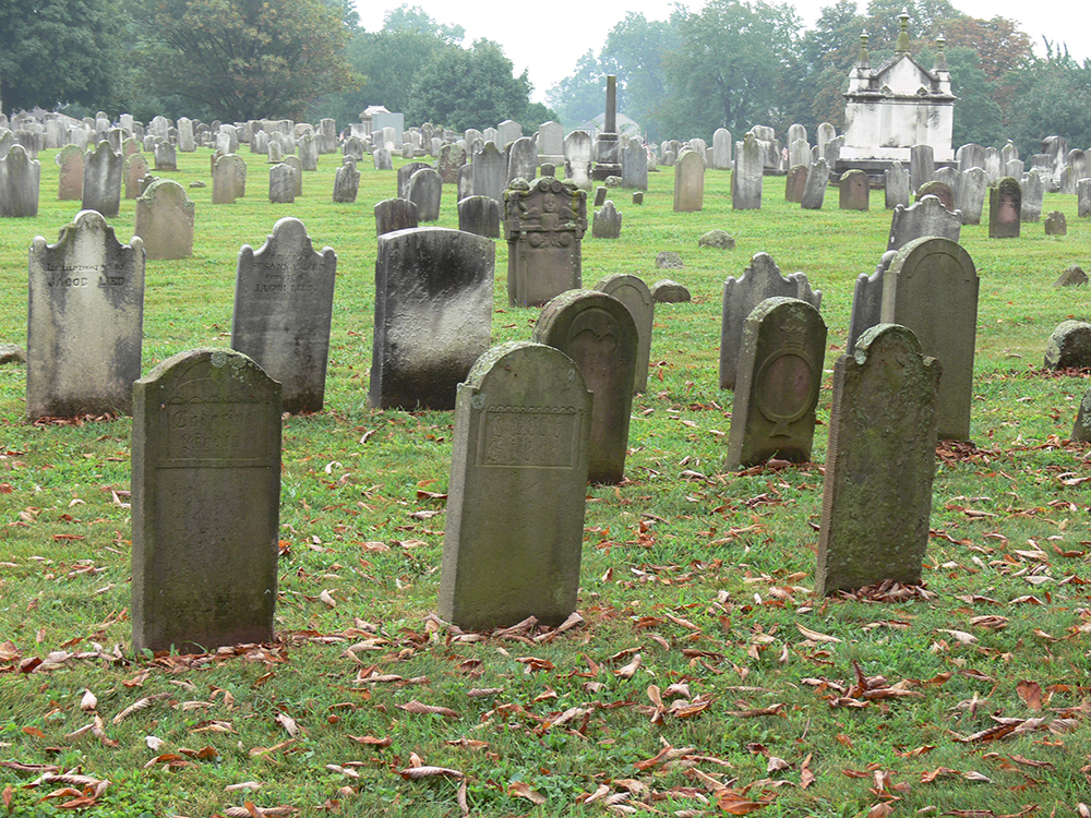 The gravestones at Muddy Creek Lutheran Church Cemetery in Denver, Lancaster County, are set in succession beginning with those from the 18th century in red sandstone and followed by those from the later 19th century in white marble. Photo, Patrick J. Donmoyer