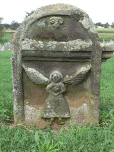 The Tulpehocken Carver made this angel figure, complete with colonial attire, in 1752. It stands in the old cemetery at Christ Evangelical Lutheran Church in Stouchsburg, Berks County. Photo, Patrick J. Donmoyer