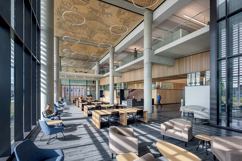 The two-story self-service area in the new State Archives building features the ash holey-wood ceiling, ash slat wall, and soffit and ash wall panels. The new building won a 2023 Construction Excellence Award from the Ceilings and Interior Systems Construction Association (CISCA). Photo, Albert Vecerka