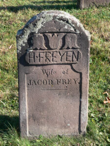 The red sandstone gravemarker for Hanna Frey at Muddy Creek Lutheran Church Cemetery in Denver shows evidence of a painted inscription, as well as a later carved inscription in English. Photo, Patrick J. Donmoyer